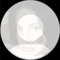 a woman's face is seen through a circular window