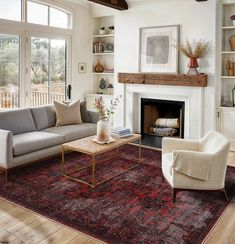 a living room filled with furniture and a fire place in the middle of a room