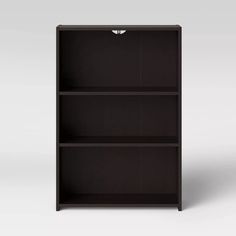 a black bookcase with three shelves on one side and two drawers on the other