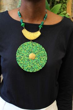 Handmade in Nairobi , Kenya!Crafted with brass and green and gold seed beads.***SHIPPINGExpress shipping (via DHL) takes 2-5 WORKING DAYS to be delivered to you. Green Round Beads Bib Necklace As Gift, Green Bib Necklace With Round Beads For Gift, Large Beads Pendant Necklace, Green Necklaces With Gold Beads, Green Beaded Chain Pendant Necklace, Green Pendant Necklace With Beaded Chain, Green Necklaces With Gold Beads For Jewelry Making, Green Necklace With Gold Beads For Gift, Green Necklace With Gold Beads As Gift