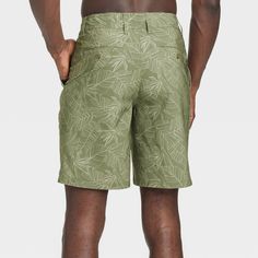 Move from the land to the sea in botanical style with these Leaf Print Hybrid Swim Shorts from Goodfellow & Co™. These hybrid swim shorts made from 4-way stretch, wrinkle-resistant fabric offer comfortable wear in or out of water. A fly button and zipper along with belt loops offers a secure fit, while the side and back pockets come in handy for stashing small essentials. Plus, the UPF 50+ rated material helps keep you protected from the sun. Pair them with your regular tees and sneakers for a c Hawaiian Style Bottoms With Built-in Shorts For Vacation, Tropical Style Swim Trunks With Built-in Shorts, Vacation Hawaiian Style Shorts, Tropical Spring Swimwear With Built-in Shorts, Fitted Hawaiian Style Bottoms For Poolside, Green Hawaiian Summer Bottoms, Summer Outdoor Bermuda Bottoms, Summer Bermuda Shorts With Built-in Shorts, 5-inch Inseam, Vacation Bermuda Shorts With Relaxed Fit