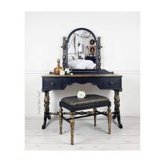 an antique vanity with mirror and stool