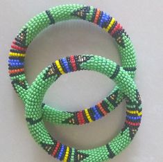 Beaded Bracelets | African Maasai Beaded Bracelets | African Jewelry | Zulu Beaded Bracelets | Ethnic Bracelets | Gift For Her | A Set Of Two These superbly crafted Zulu beaded bracelets are made of fine beads.The price is for a set of two bracelets.Main Color - Green.Size - Standard measurement is 7 - 8 inches.For smaller or larger bracelets please contact me.Available in different colors.Feel free to send me a convo or e-mail for any clarification.Thank you for visiting... Green Bangle Friendship Bracelets, Traditional Green Friendship Bracelets, Artisan Green Beaded Bracelets With Round Beads, Artisan Green Beaded Bracelets, Bohemian Bangle With Colorful Beads, Artisan Green Bangle Bracelet, Green Bead Bracelet For Festivals, Green Beaded Friendship Bracelets For Festivals, Handmade Green Bracelets For Festivals