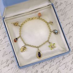 This 14k gold charm bracelet features 8 gemstone and enamel charms -- most were originally antique stickpins (circa 1910).  Two of the charms are 10k gold, but the others are all 14k.   The bracelet measures 7 inches long and weighs 7.9 grams. It is in good condition with some loss to the enamel on two of the flower charms and some replacement pearls on the opal charm.  We have many other fantastic offerings of fine jewelry posted on our Etsy store, so please consider browsing our other items. W Adjustable Gold Charm Bracelet With Vintage Charm, Vintage Gold-tone Charm Bracelet As Gift, Gold-tone 14k Gold Charm Bracelet, Gold-tone Vintage Charm Bracelet Gift, Antique Charm Bracelet, Vintage Gold-tone Metal Charm Bracelet, Jeweled Bag, Turtle Charm, Jewelry Post