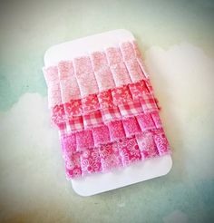 a white cutting board topped with pink squares