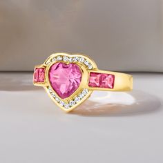 Ross-Simons - 3.20ct t. w. Pink Topaz, .18ct t. w. Diamond Heart Ring Over Sterling. Size 8. Stand out on date night with our glitzy ring! It flaunts a radiant 2.00 carat heart-shaped pink topaz accentuated by a sparkly halo of .18 ct. t. w. round diamonds and additional 1.20 ct. t. w. square pink topaz gems trailing either side. Crafted in 18kt yellow gold over sterling silver. 1/2" wide. Diamond and pink topaz heart ring. Cubic Zirconia Heart Ring For Valentine's Day Proposal, Mother's Day Heart Cut Cubic Zirconia Heart Ring, Glamorous Heart Cut Jewelry For Valentine's Day, Valentine's Day Proposal Heart Ring In Cubic Zirconia, Valentine's Day Proposal Cubic Zirconia Heart Ring, Valentine's Day Proposal Heart Ring With Cubic Zirconia, Valentine's Day Heart Ring In Cubic Zirconia, Valentine's Day Cubic Zirconia Heart Ring, Valentine's Day Cubic Zirconia Birthstone Ring