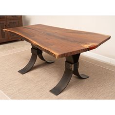 a wooden table sitting on top of a carpeted floor