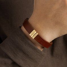 "This leather bracelet is engraved with kids' names. Available in sterling silver with 18K gold plate options, this is the perfect gift for Dad on Father's day, at Christmas or a special day. You can select the number of kids' charms P R O D U C T ∙ I N F O * Word limit: 9 letters/charm * Materials: Genuine Leather with sterling silver charms. * Finishing: Silver, Gold * Dimensions: Leather width measures .approx 3/8\"\" (11mm). The charm measures approx. 1/2\"x 1/8\" (13x3mm). * Size: We have 3 Modern Bracelets For Father's Day Gift, Modern Bracelet For Father's Day Gift, Adjustable Jewelry With Engraving Option For Birthday Gift, Rectangular Leather Jewelry With Engraving, Rectangular Leather Engraved Jewelry, Customizable Name Bracelet For Father's Day, Gold Leather Bracelet For Gift, Gold Leather Bracelets As Gift, Gold Leather Bracelet As Gift