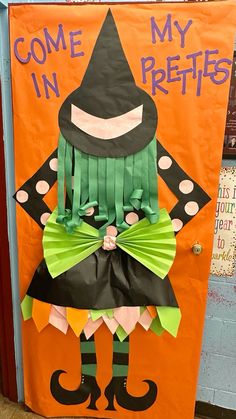 an orange door decorated with a scarecrow and green bow tie, wearing a black witch costume