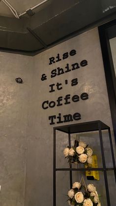 there is a sign on the wall that says rise and shine it's coffee time