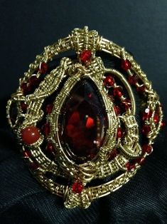 a gold ring with red stones on it