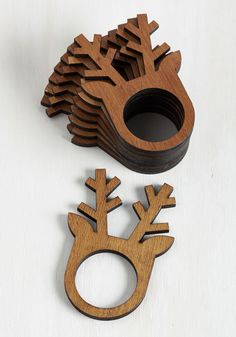 a wooden ring holder with an animal design on the front, and a pine wood ring holder in the back