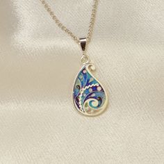 100% handmade sterling silver pendant. Pendant covered with hot cloisonné enamel. Cloisonné  is an ancient technique for decorating metalwork objects with colored material held in place or separated by metal strips or wire, normally of gold or silver. This process is quite laborious, because all the details require hand processing. Georgian cloisonné enamel counts more than 1200 years of history.  Our handmade pendants, earrings, brooches are vibrant with colour and compliment any outfit, prefered for daily wear or a special occasion. Materials: Sterling Silver, Fine Silver, Cloisonne enamel Weight - 2.5 gr (approx) Height - 2 cm; 0.8 inches Width - 1.2 cm; 0.5 inches  About it: Our jewelry pieces are created using a combination of enameling and metal clay techniques. The Cloisonné focal i Traditional Teardrop Necklace For Gift, Traditional Teardrop Pendant Jewelry Gift, Blue Enamel Bohemian Necklaces, Unique Turquoise Enamel Jewelry, Sterling Silver Teardrop Jewelry With Artistic Design, Sterling Silver Necklace With Artistic Design, Hand Painted Blue Sterling Silver Necklace, Enamel Hallmarked Oval Pendant Necklace, Engraved Enamel Necklaces For Gifts