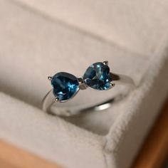 two blue stone rings sitting in a box