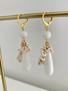 Introducing my exquisite Beaded White Jade teardrop earrings, perfect for adding a touch of elegance to any occasion. Round White Jade bead and mini beaded flowers is delicately placed to create a mesmerizing design and looks super cute. The 10x30mm natural White stone teardrop adds an extra dimension to these earrings, making them a unique and glamorous accessory. With a total lenght of 7 cm including the latch back closure, these earrings are the perfect size to make a statement without being Delicate White Teardrop Flower Earrings, White Pearl Drop Dangle Cluster Earrings, White Pearl Drop Cluster Earrings, Gemstone Beads Dangle Earrings For Jewelry Making, Gemstone Beaded Dangle Earrings For Jewelry Making, Dangle Beaded Earrings With Gemstone Beads For Jewelry Making, Handmade White Long Drop Teardrop Earrings, White Teardrop Flower Earrings, Elegant Faceted Dangle Beaded Earrings