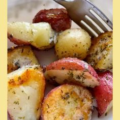 a white plate topped with potatoes and meat