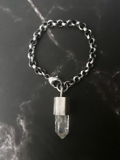 QUARTZ AMULET BRACELET. COLOR: CRYSTAL QUARTZ+ OXIDIZED, TEXTURED SILVER. CHAIN: 6.3mm ROLO VISIBLE CRYSTAL: 0.71" [18.1mm] SIZE: S: 17.78cm long for a 16cm wrist [7" long for a 6.3" wrist] Chain Bracelet are sized based on the circumference of your wrist. BEFORE ORDERING, PLEASE READ THE DESCRIPTION CAREFULLY, ANY ADDITIONAL INFO CAN BE OBTAINED BY ETSY MESSAGE OR DM ME ON INSTAGRAM @furia_metalsmith. Sterling Silver Faceted Crystal Bracelet Gift, Spiritual Silver Crystal Bracelet With Gemstone, Silver Gemstone Crystal Bracelet For Spiritual Healing, Unique Handmade Silver Crystal Bracelet, Handmade Silver Pendant Bracelets, Spiritual Sterling Silver Chain Bracelet, Luxury Faceted Silver Bracelets, Spiritual Silver Quartz Jewelry, Silver Quartz For Jewelry Making