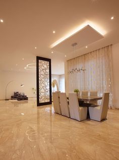 an elegant dining room with marble flooring and white walls, along with high ceiling lighting