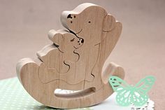 a wooden rocking horse with a baby in the back and a butterfly on the ground