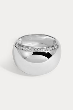 Bold and lightweight, this smooth domed design is embellished with pavé detailing along both edges of the ring. Available in 14kt gold plated brass or Rhodium plated brass Stones are White Cz, and measure 1.0mm each Dome width measures approx. 15mm Dome height measures approx. 4mm Runs true to size Product Care: METAL: Use a soft cloth to gently wipe clean, then remove any remaining impurities with mild diluted soap. Rinse with warm water and dry thoroughly before storing in the provided jewelry Lili Claspe Jewelry, Dome Ring, Domed Ring, Platinum Ring, Jewelry Cleaner, 14kt Gold, Jewelry Pouch, Rhodium Plated, Warm Water