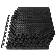 black rubber flooring tiles with different sizes and shapes on top of each other,