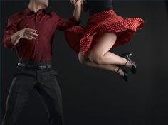 a man and woman are dancing in the air