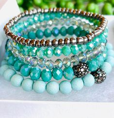 Set of 5 Bead Bracelets  Wear all together or individually  Available in Island Blue or Smokey Gray Size 18 cm Stretch Band to Fit Most Sizes  Arrives in Gift Box  Fast Shipping Turquoise Stretch Bracelet With Stackable Round Beads, Turquoise Stackable Stretch Bracelet With Round Beads, Turquoise Stretch Bracelet With Round Beads, Blue Crystal Bracelet With Stackable Round Beads, Turquoise Stackable Beaded Bracelets With Round Beads, Turquoise Crystal Bracelet With Colorful Beads, Turquoise Stretch Bracelet With Faceted Beads, Turquoise Beaded Stretch Bracelet With Round Beads, Turquoise Crystal Bracelet With Faceted Round Beads