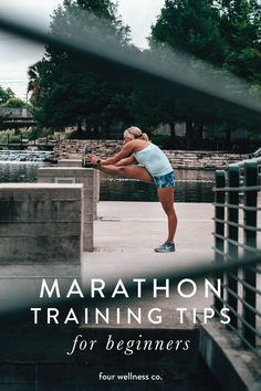 a woman stretching her legs with the words marathon training tips for beginners