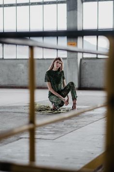 a woman sitting on the ground with her legs crossed