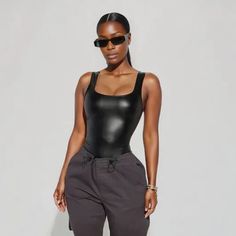 Get ready to show off your unique style with our faux leather square neck bodysuits! This contemporary piece is form fitting and bold enough to make you stand out from the crowd. Don't miss out on this edgy and versatile item! Modern Stretch Bodysuit For Party, Modern Stretch Party Bodysuit, Fitted Black Modern Bodysuit, Modern Black Fitted Bodysuit, Modern Fitted Black Bodysuit, Chic Second-skin Bodysuit For Night Out, Modern Black Stretch Bodysuit, Sleek High Stretch Bodysuit For Night Out, Modern Fitted Bodysuit For Night Out