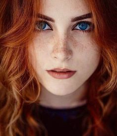 a woman with red hair and blue eyes