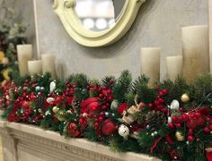 a mantel with candles and christmas decorations