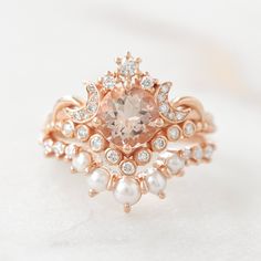 an image of a ring with diamonds and pearls on the bottom, set in rose gold