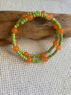 Handmade Pastel Orange Jade and Lime Green Glass Beaded Bracelet/ Choker. This pastel piece is the perfect accessory for the summer! Inspired by orange trees from the streets of Granada  add a little zest to your outfit!  I love wearing these as chokers but they can adjust easily to any adult wrist as a bracelet also. Match it with some popping nail polish or a bold lipstick or just your natural beautiful self. 🧡💚 All items come in recyclable, earth friendly packaging. Please message me if you Bohemian Orange Beaded Bracelets With Large Beads, Green Beaded Bracelets For Beach In Spring, Green Casual Beads For Summer, Casual Green Beads For Summer, Bohemian Bracelets With Large Beads For Summer, Casual Orange Beaded Bracelets With Round Beads, Green Bohemian Beaded Bracelets For Spring, Bohemian Orange Jewelry For Spring, Orange Beaded Bracelets With Colorful Beads For Vacation