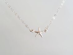 "Tiny starfish pendant. The sterling silver starfish charm is a dainty 9mm with a shiny finish. It has a delicate sterling silver chain and clasp. Shown here in 16\" length. *If you are unsure of the length you need, or would like to wear this item at different lengths, we now offer an adjustable length option! You can add an adjustable end to your necklace using this link: https://www.etsy.com/listing/791277751/necklace-extension-added-to-your Also available in 14k gold fill as seen in the last Sterling Silver Starfish Charm Necklace, Sterling Silver Starfish Necklace With Star Charm, Sterling Silver Necklace With Starfish Charm, Necklace Extension, Beach Items, Starfish Pendant, Starfish Necklace, Solid Gold Jewelry, Jewelry Cleaner