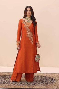 Traditional Orange Pakistani Salwar Kameez Dupatta Suit is magnified by an array of vibrant precious stones, each one catching the light in a dance of color. Orange Salwar Kameez, Long Kameez, Elegant Pants, Pakistani Clothes Online, Pakistani Designer Clothes, Pakistani Formal Dresses, Raw Silk Fabric, Elegant Pant, Pakistani Salwar