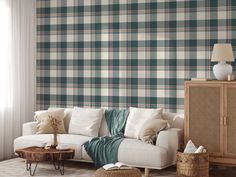 a living room scene with focus on the couch and plaid wallpaper behind the sofa