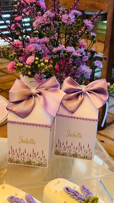 two cakes with purple flowers in the background