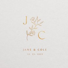 a white envelope with gold foiling on the front and bottom, which reads j c