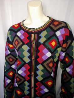 a mannequin wearing a multicolored sweater