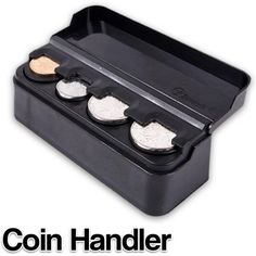 the coin holder is black and has three coins in it, which are sitting on top of each other