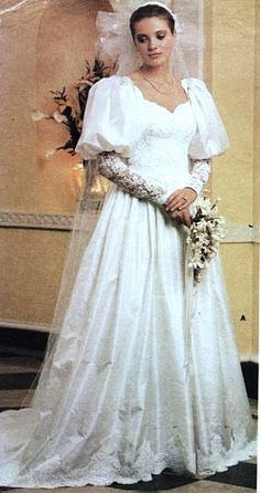 a woman in a white wedding dress and veil