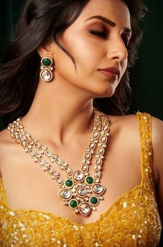 Introducing an exquisite double-layer Kundan necklace adorned with radiant Kundan stones, accompanied by matching earrings, all set in mixed metal with opulent 22kt gold plating, offering an enchanting blend of tradition and elegance. Finish: 22KT Gold Plating Material: Brass, Kundan Color: Gold, Green & White Size: Free Size, Adjustable Closure Type: Draw String Box Contains: 1 Necklace, 1 Pair of Earrings Opulent Bridal Necklace With Intricate Design For Festive Occasion, Festive 22k Gold Emerald Necklace, Opulent Formal Festive Jewelry, Opulent Festive Formal Jewelry, Gold Chandbali Bridal Necklace With 17 Jewels, Fusion Gold Jewelry Sets For Diwali, Festive Kundan Emerald Necklace For Receptions, Festive Gold Kundan Necklace For Reception, Gold Emerald Necklace With Intricate Design For Festive Occasions