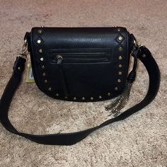 Great American Leatherworks Black Leather Bronze Studded Satchel Shoulder Bag 8.5"H X 9.5"W X 3.5"D Magnetic Snap Closure -- Removable Strap Outer-- Front Zipper Pocket, Back Pocket W/ Magnetic Snap Closure Inner-- 1 Zipper Pocket, 2 Media Pockets Comes With Adorable Chain Tassel Brand New With Tags & Beautiful! Black Faux Leather Bags With Gold-tone Hardware, Black Crossbody Satchel For Fall, Black Fall Crossbody Satchel, Black Faux Leather Shoulder Bag With Gold-tone Hardware, Black Faux Leather Shoulder Bag With Metal Hardware, Black Satchel With Detachable Strap, Black Faux Leather Crossbody Satchel, Fall Evening Shoulder Bag With Metal Hardware, Black Crossbody Satchel With Metal Hardware