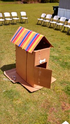 an open cardboard box on the ground with chairs in the background