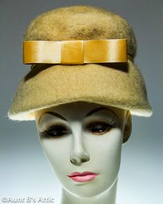 "Simple, but elegant, is this vintage 50's ladies NECO 100% wool bucket style hat. Beige wool felt, with a beige satin cord and bow. Grosgrain ribbon inner band. Union made in the U.S. by the United Hatters Cap & Millinery Workers. Inner band measures appx. 22\" Hat opening measures appx. 8 3/4\" x 8 1/4\" App.x height-6\" Overall condition is good, there are some moth bites but no holes. **Please Note- All of my vintage and antique items are sold as is. Any flaws, and or damage will be disclose Vintage Wool Cloche Hat, Vintage Beige Felt Hat For Winter, Vintage Cream Brimmed Felt Hat, Vintage Cream Felt Hat With Short Brim, Vintage Beige Cloche Hat For Winter, Vintage Beige Winter Cloche Hat, Vintage Beige Hat For Winter, Beige Vintage Cloche Hat For Party, Vintage Winter Cloche Hat For Wedding