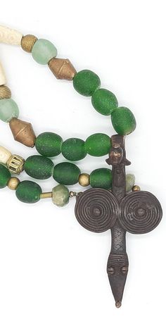 PEINTURE DE LOBI Tribal necklace with LOBI pendant,Bone Beads and green powder glas beads  . . . antique BONE beads,with carved pattern,about 45-50 years old, from Westafrica, various brass/messing beads from Westafrica ("lost form"), green KROBO beads (light - and dark green) made from powderglas, from Westafrica, 2 dark green beads made from antique glas, facet cut,from India, . . . a dream-beautiful pendant of the LOBI  (PROTECTION PENDANT) Total lenght incl. pendant : about 32.28 inch Pendan Green Beaded Jewelry In Recycled Glass, Green Beaded Jewelry From Recycled Glass, Green Beaded Jewelry With Recycled Glass, Green Beaded Necklaces With Recycled Glass For Gifts, Green Recycled Glass Beaded Necklaces For Gifts, Green Recycled Glass Beaded Necklace As Gift, Green Recycled Glass Beaded Necklace Gift, Spiritual Recycled Glass Beads For Gifts, Handmade Symbolic Green Necklace