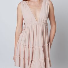 This Deep V Swing Dress Showcases An Alluring Silhouette With Beautiful Ruffle And Lace Up Side Cut Out Details. Perfect For A Beach Or Boho Look, This Dress Will Make You Stand Out In Any Occasion. Self 100% Rayon Chic V-neck Beach Dress For Summer Outings, V-neck Sundress For Summer Outings, Breezy V-neck Mini Dress For Vacation, Breezy Mini Dress For Beach Cover-up, Breezy V-neck Mini Dress For Day Out, Summer Tiered Beach Dress, Tiered Beachwear Dress For Beach, Breezy Tiered Mini Dress For Vacation, Bohemian Tiered Mini Dress For Beach