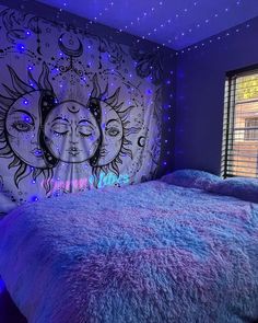 a bedroom with purple and blue lights on the walls