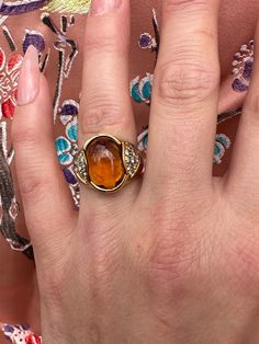 Very unusual vintage Citrine and diamond ring with center stone cabochon citrine diamond on either side , approx .36 Ct of diamond made in 18k size 5.75 , 8.53 grams . Formal Orange Topaz Ring With Diamond, Formal Citrine Ring With Diamond Accents, Formal Orange Diamond Ring, Elegant Yellow Cabochon Rings, Elegant Orange Rings With Gemstone Accents, Elegant Amber Rings With Gemstone Accents, Formal Orange Rings With Gemstone Accents, Orange Rings With Gemstone Accents For Formal Occasions, Vintage Diamond Rings With Gemstone Accents